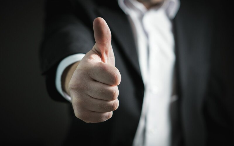 Man in suit thumbs up