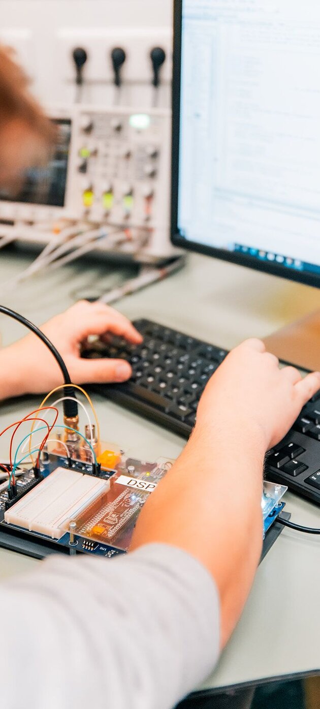 Een student maakt een testopstelling voor elektronica